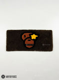 BAPE Ape Head hand-tufted keyboard rug featuring a brown, black, orange, and yellow streetwear graphic on a plush rectangular desk rug by Mayur Rugs.