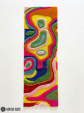 Colorful wavy abstract hand-tufted wool runner rug featuring flowing pink, yellow, green, blue, orange, red, and pastel organic patterns in a vibrant modern design by Mayur Rugs.