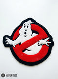 Ghostbusters inspired hand-tufted custom wool rug featuring a white ghost over a red circle with black background, raised 3D details, and a custom circular silhouette by Mayur Rugs.