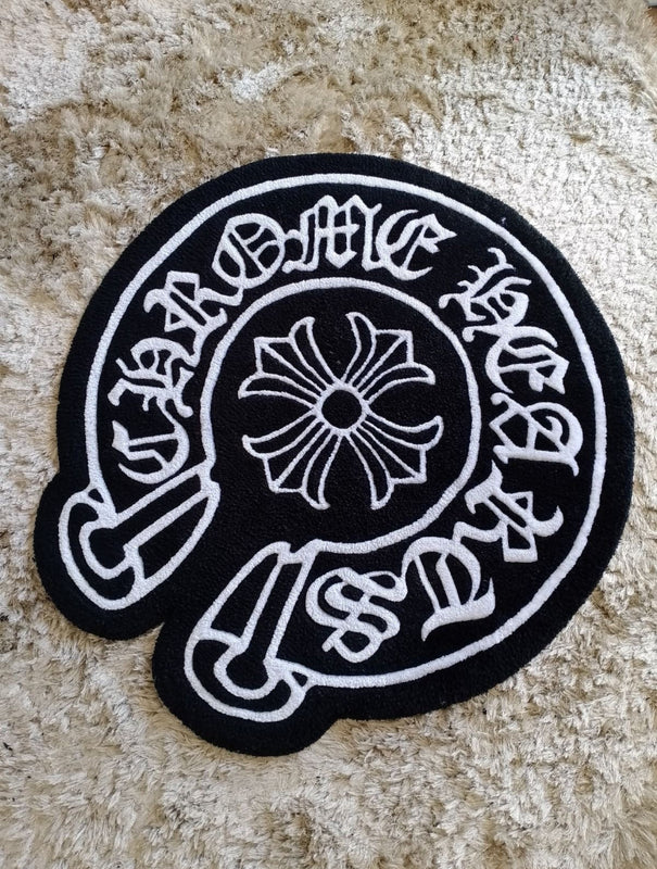 Black and white embroidered patch with circular design and text on a textured surface