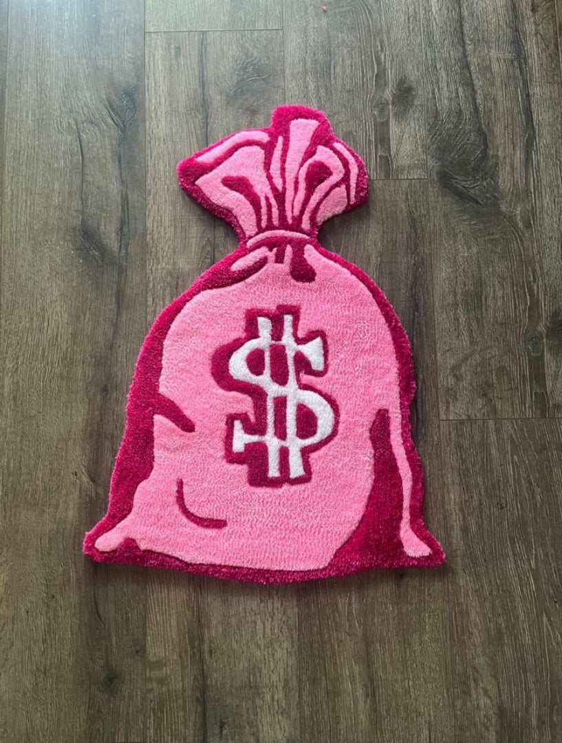 Pink bag with dollar sign on a wooden floor