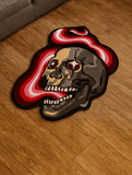 Skull-shaped rug with red and white design on a wooden floor