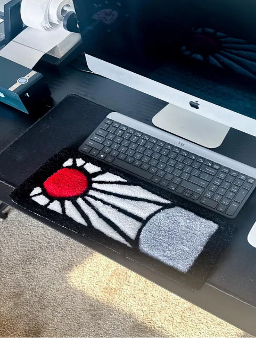 Desk setup with a computer monitor, keyboard, and mouse on a desk.