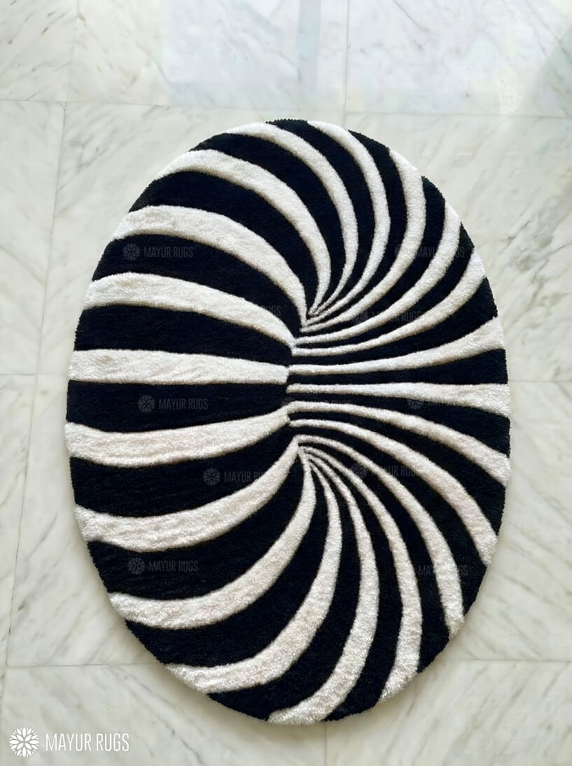 Black and white spiral patterned rug on a light-colored floor.