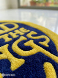 Close-up of a blue and yellow rug LOTR typography round hand-tufted wool rug with fantasy cinematic aesthetic design by Mayur Rugs