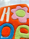 HOPE typography hand-tufted wool rug with minimalist inspirational aesthetic design by Mayur Rugs