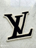 LV logo inspired custom hand-tufted wool rug with luxury streetwear aesthetic design by Mayur Rugs