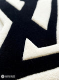 LV logo inspired custom hand-tufted wool rug with luxury streetwear aesthetic design by Mayur Rugs