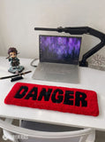 Danger typography hand-tufted wool rug with bold red and black statement design by Mayur Rugs