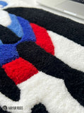 BMW M Inspired hand-tufted keyboard rug with luxury automotive gaming desk setup aesthetic by Mayur Rugs