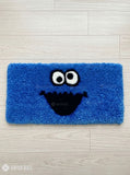 Blue monster-inspired hand-tufted keyboard rug with playful cartoon aesthetic by Mayur Rugs