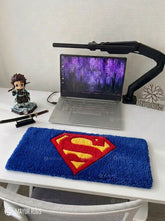 Superman inspired hand-tufted keyboard rug with superhero gaming aesthetic by Mayur Rugs