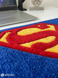 Superman inspired hand-tufted keyboard rug with superhero gaming aesthetic by Mayur Rugs