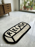 Relax pill-inspired hand-tufted wool rug with modern chill aesthetic and plush texture by Mayur Rugs