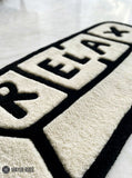 Relax pill-inspired hand-tufted wool rug with modern chill aesthetic and plush texture by Mayur Rugs