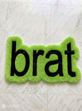 Lime green brat text hand-tufted wool rug featuring bold typography aesthetic by Mayur Rugs