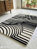 Abstract human illusion hand tufted wool rug featuring black and white optical art contour line design by Mayur Rugs