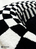 Handtufted black and white optical illusion vortex wool rug with checkerboard geometric design by Mayur Rugs