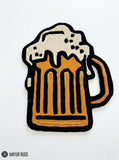 Beer stein hand tufted wool rug featuring overflowing foam and pub inspired artwork by Mayur Rugs