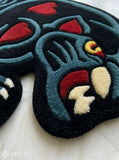 Black Panther tattoo style hand tufted area rug with red heart details handmade by Mayur Rugs