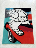 KAWS Racing Companion hand tufted wool rug featuring XX-eyed skull artwork leaning from a sports car by Mayur Rugs.