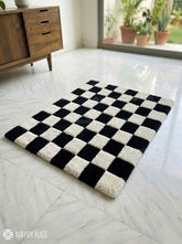 Black and white checkerboard hand tufted wool area rug featuring a classic geometric checkered pattern by Mayur Rugs.