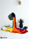 Rainbow paint spill hand tufted wool wall art rug featuring a colorful tipped paint bucket and flowing rainbow design by Mayur Rugs.