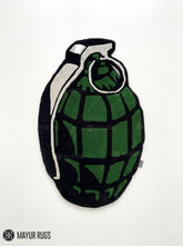 Grenade hand tufted custom wool rug featuring military tactical artwork with olive green grenade design by Mayur Rugs.