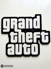 Grand Theft Auto logo hand tufted custom wool rug featuring fan-inspired gaming typography by Mayur Rugs.