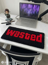 Wasted GTA inspired hand tufted keyboard rug featuring iconic gaming typography by Mayur Rugs.