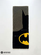 Batman minimal hand-tufted rug handmade in India by Mayur Rugs featuring a sleek black silhouette with the iconic yellow bat emblem in a modern superhero-inspired design.