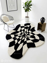 Black and white optical illusion hand-tufted wool rug featuring a distorted 3D geometric vortex pattern and modern op-art design by Mayur Rugs.