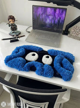 Tangela inspired Pokémon 3D hand-tufted keyboard rug featuring a blue tangled-vine character design with large white eyes and raised plush detailing for gaming and anime desk décor by Mayur Rugs.