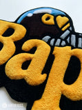 BAPE inspired ape head hand-tufted custom wool rug featuring oversized raised orange Bape typography, black graphic base, and a blue-and-white cap-wearing ape character by Mayur Rugs.
