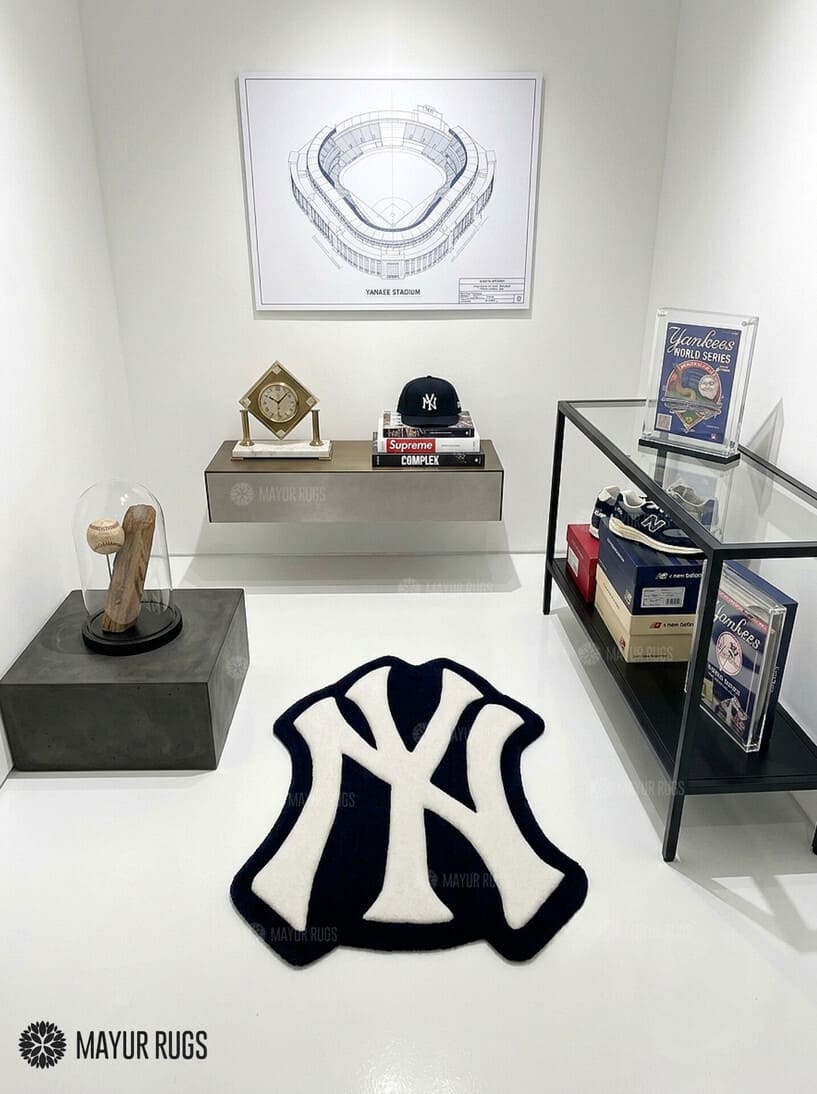 New York Yankees inspired hand-tufted custom wool rug featuring a cream interlocking NY baseball logo on a black background by Mayur Rugs.
