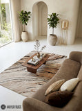 Modern flow silk-inspired hand-tufted wool area rug featuring flowing black, cream, beige, taupe, and soft peach organic lines in a contemporary abstract luxury design by Mayur Rugs.