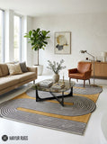 Mustard wave line geometric hand-tufted wool area rug featuring continuous charcoal grey and ivory curved lines over a warm mustard-yellow background in an abstract maze-inspired pattern by Mayur Rugs.