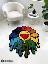 Custom-shaped hand-tufted rug featuring a yellow smiley flower surrounded by red, orange, purple, blue, teal, and green dripping petals with black outlines by Mayur Rugs.