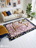 Blush Pebble abstract hand-tufted wool area rug featuring a dusty pink center, raised ivory pebble shapes, a navy blue border with mustard-gold motifs, and a terracotta-red accent by Mayur Rugs.