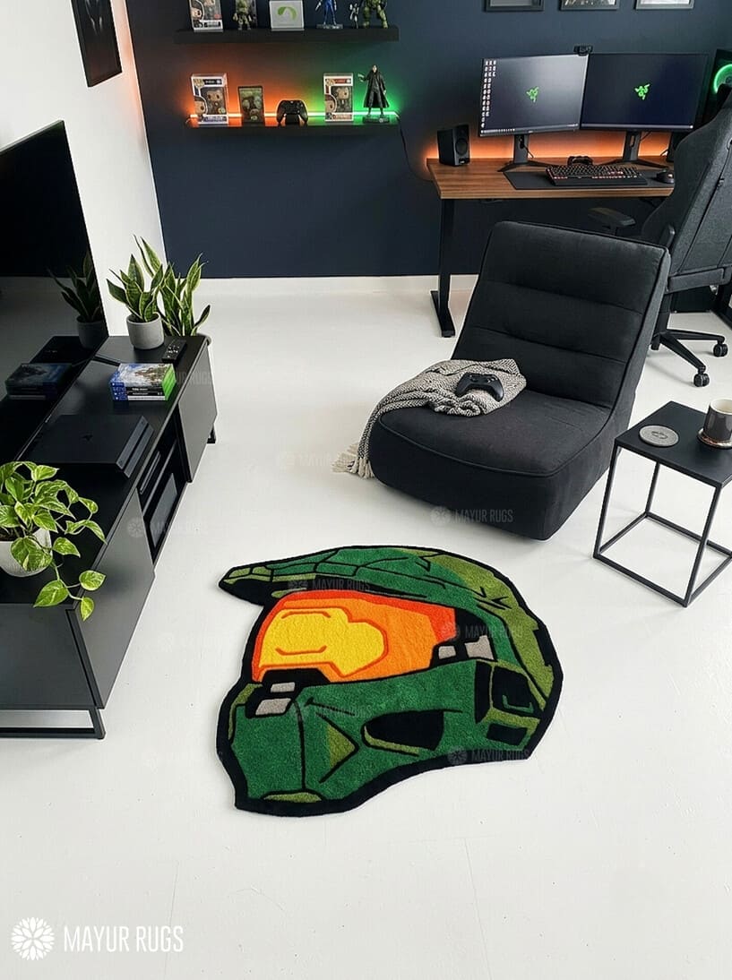 Custom-shaped green sci-fi Spartan helmet rug featuring an orange-gold visor, black outlines, and angular armor details inspired by Halo's Master Chief.