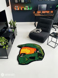 Custom-shaped green sci-fi Spartan helmet rug featuring an orange-gold visor, black outlines, and angular armor details inspired by Halo's Master Chief.