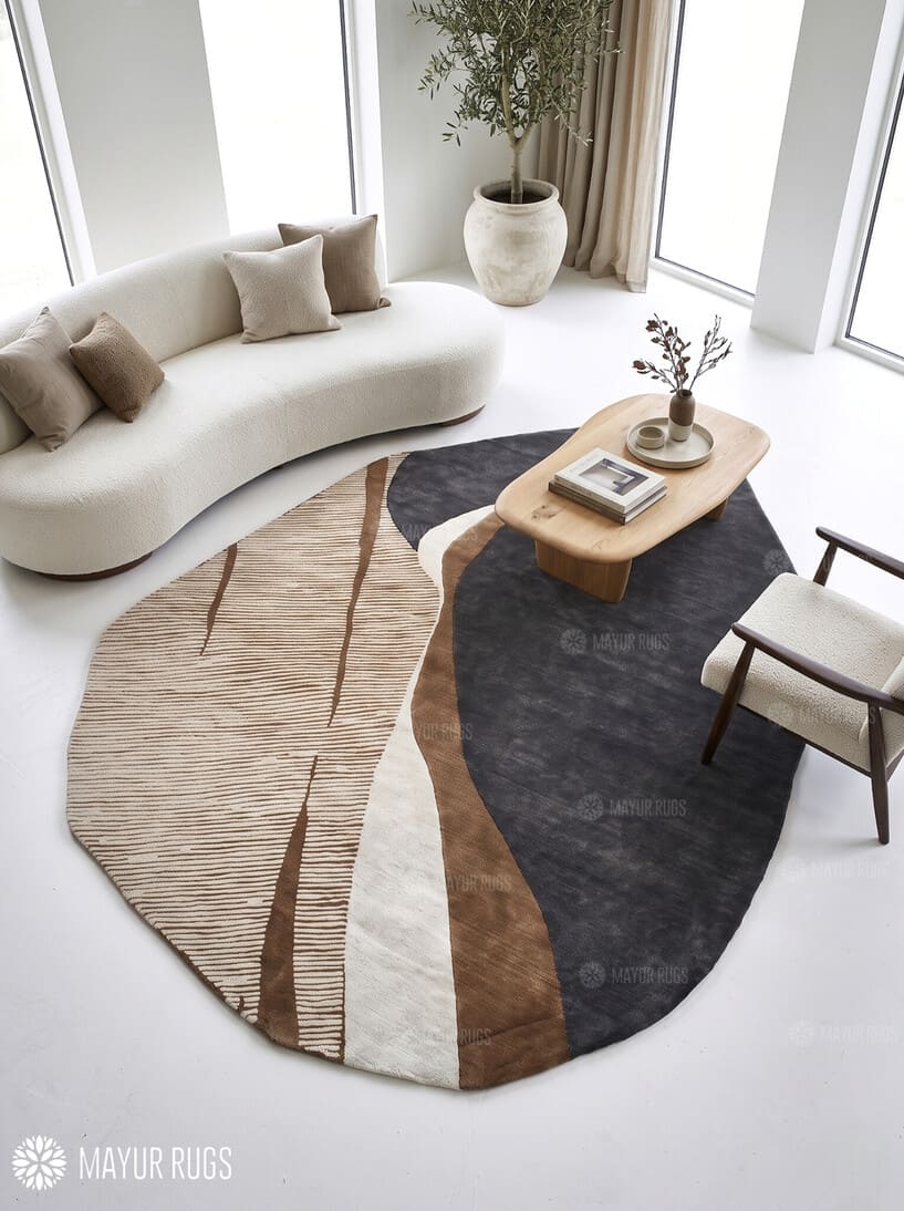 Modern abstract rug with an irregular organic shape, charcoal grey sections, taupe and brown curves, ivory bands, and fine linear detailing by Mayur Rugs.