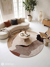 Round abstract area rug featuring flowing organic shapes in beige, ivory, taupe, chocolate brown, and rust tones by Mayur Rugs.