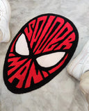 Spider-Man inspired hand-tufted custom wool rug featuring a red and black superhero mask design with large white eyes and graphic web detailing by Mayur Rugs.