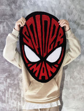 Spider-Man inspired hand-tufted custom wool rug featuring a red and black superhero mask design with large white eyes and graphic web detailing by Mayur Rugs.