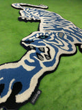 Blue and white tiger-shaped rug on a tiled floor