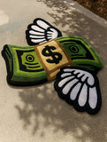 Decorative rug with money design and wings on a textured surface
