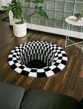 Black and white checkered round rug on a wooden floor with a plant and small table in the background.