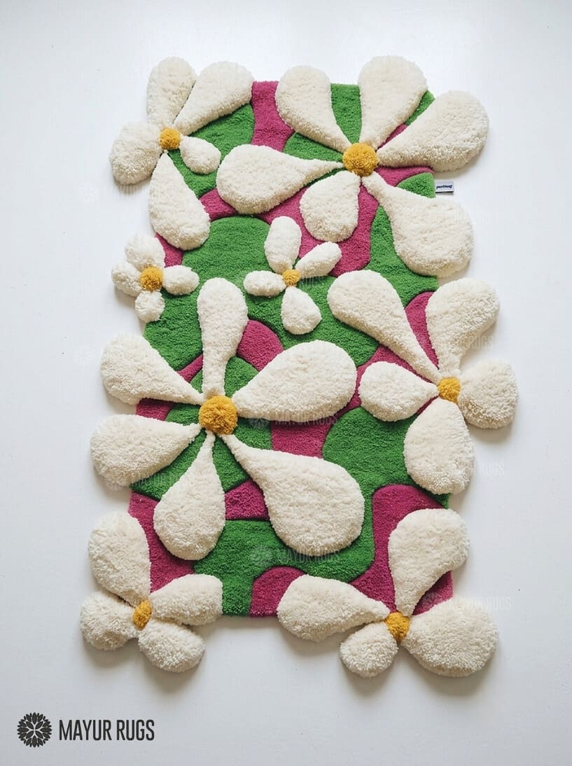 Blooming garden 3D hand-tufted wool area rug featuring raised cream-white flowers with golden centers over a vibrant pink and green organic botanical pattern by Mayur Rugs.