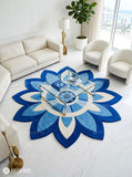 Blue rangoli floral hand-tufted wool area rug featuring symmetrical blue and ivory petals, concentric circles, and mandala-inspired Indian decorative artwork by Mayur Rugs.